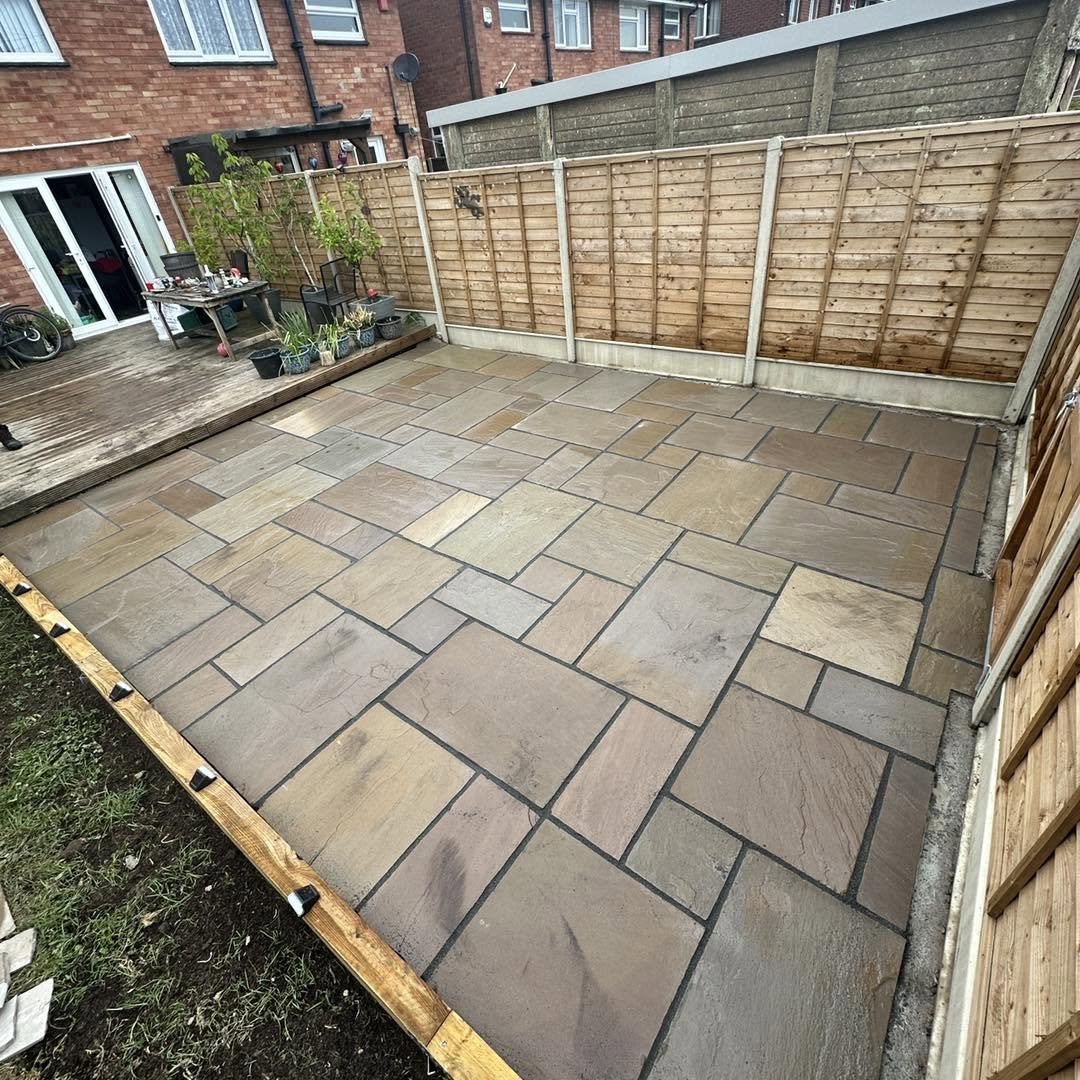Indian sandstone patio with multi-size riven slabs and new timber edging
