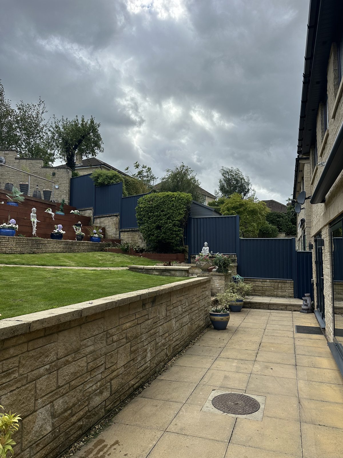 After: anthracite metal fencing manufactured from Colorbond steel finishing the boundary