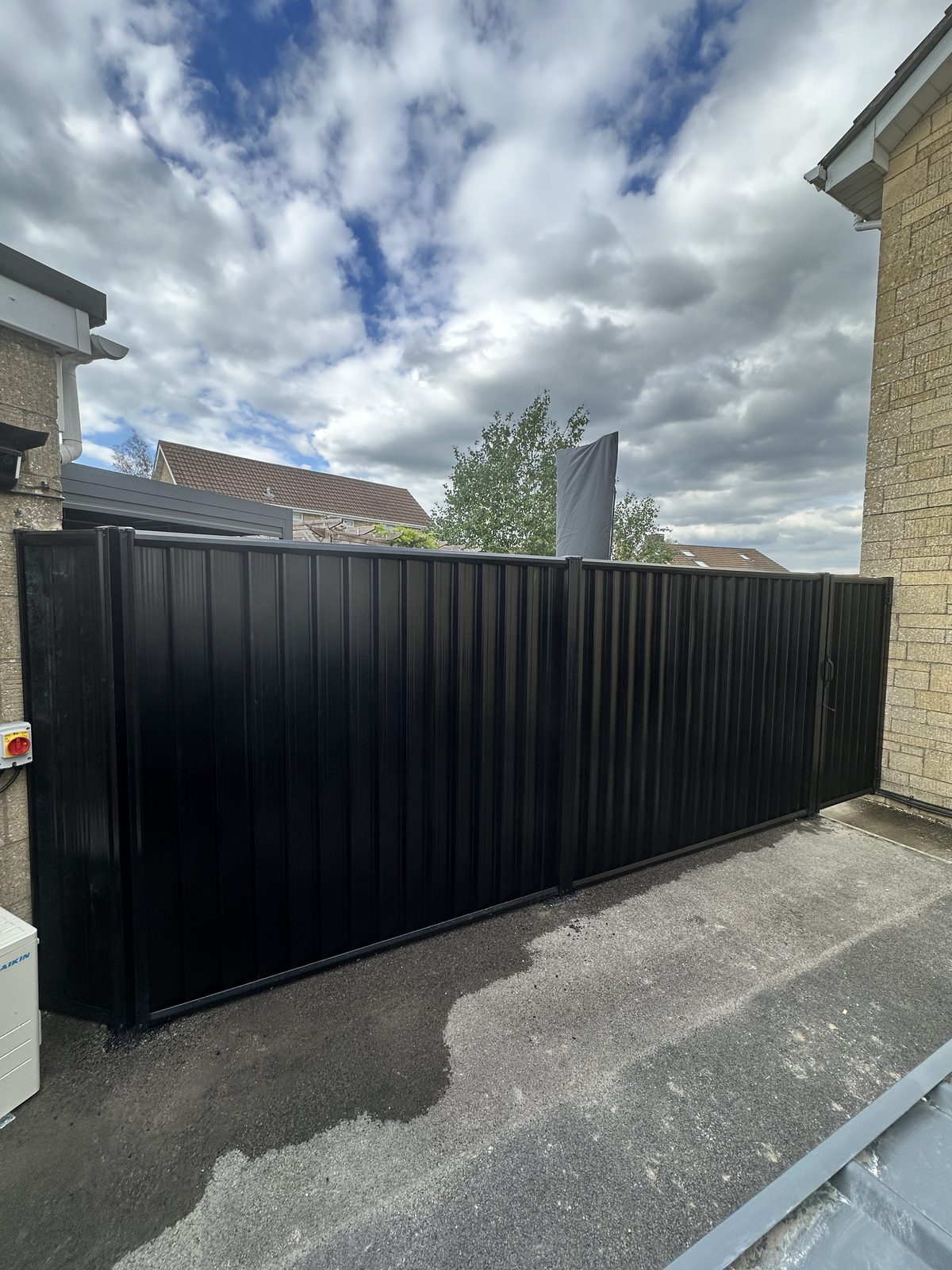 After: black metal fencing and matching gates manufactured from Colorbond steel