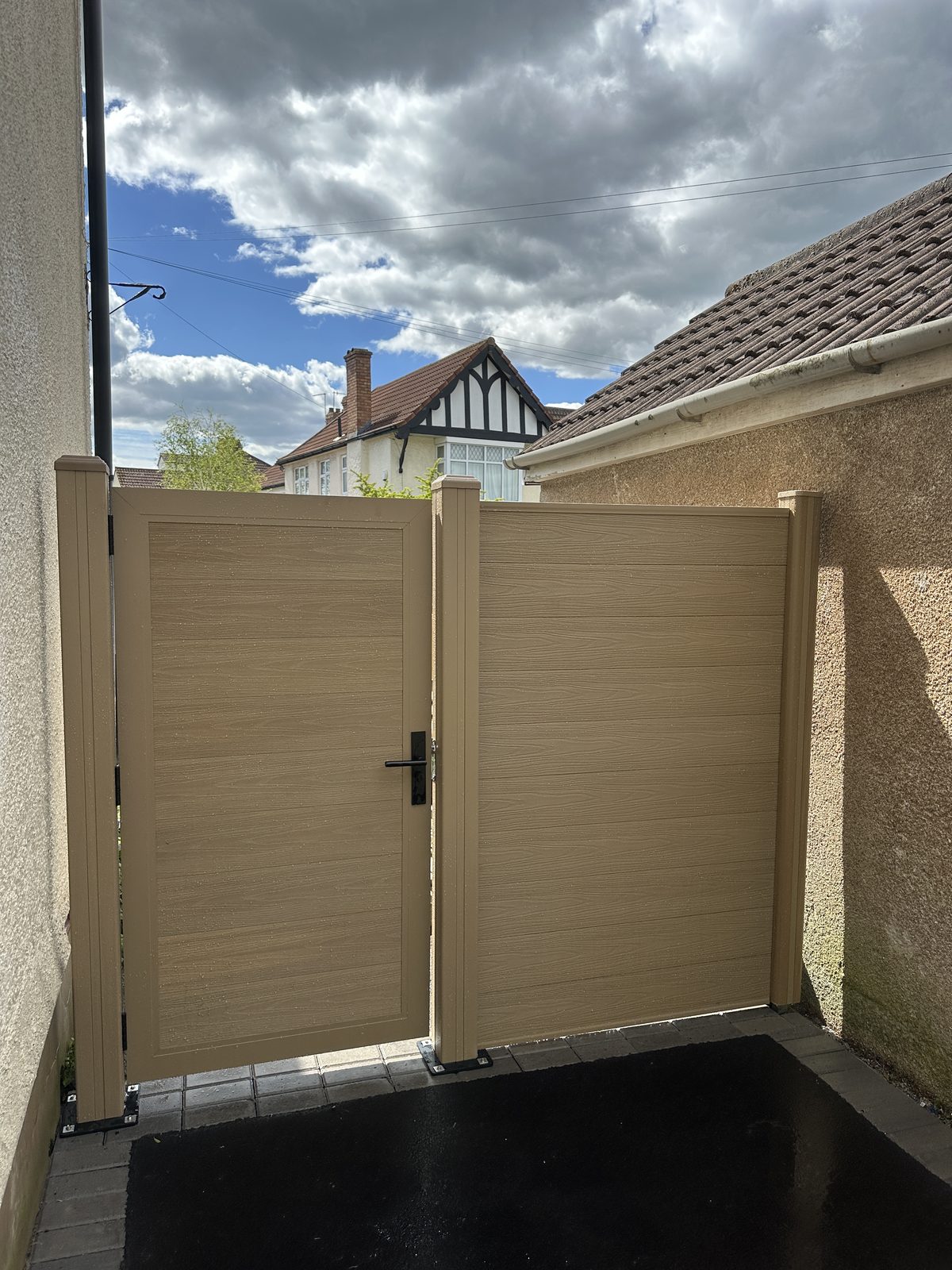 Oak-effect composite double gates with matching composite fencing