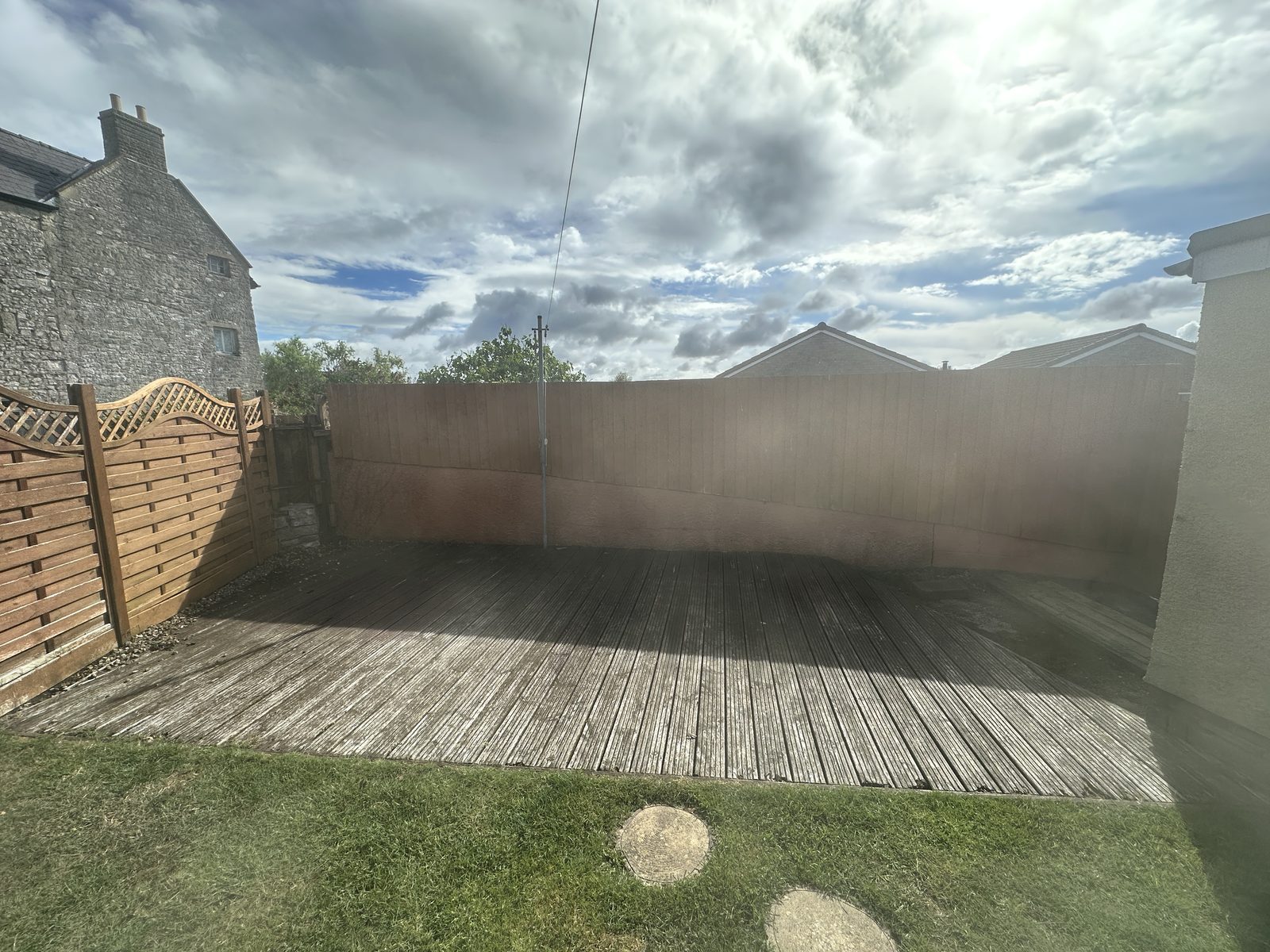 Before: tired, weathered timber decking in a back garden