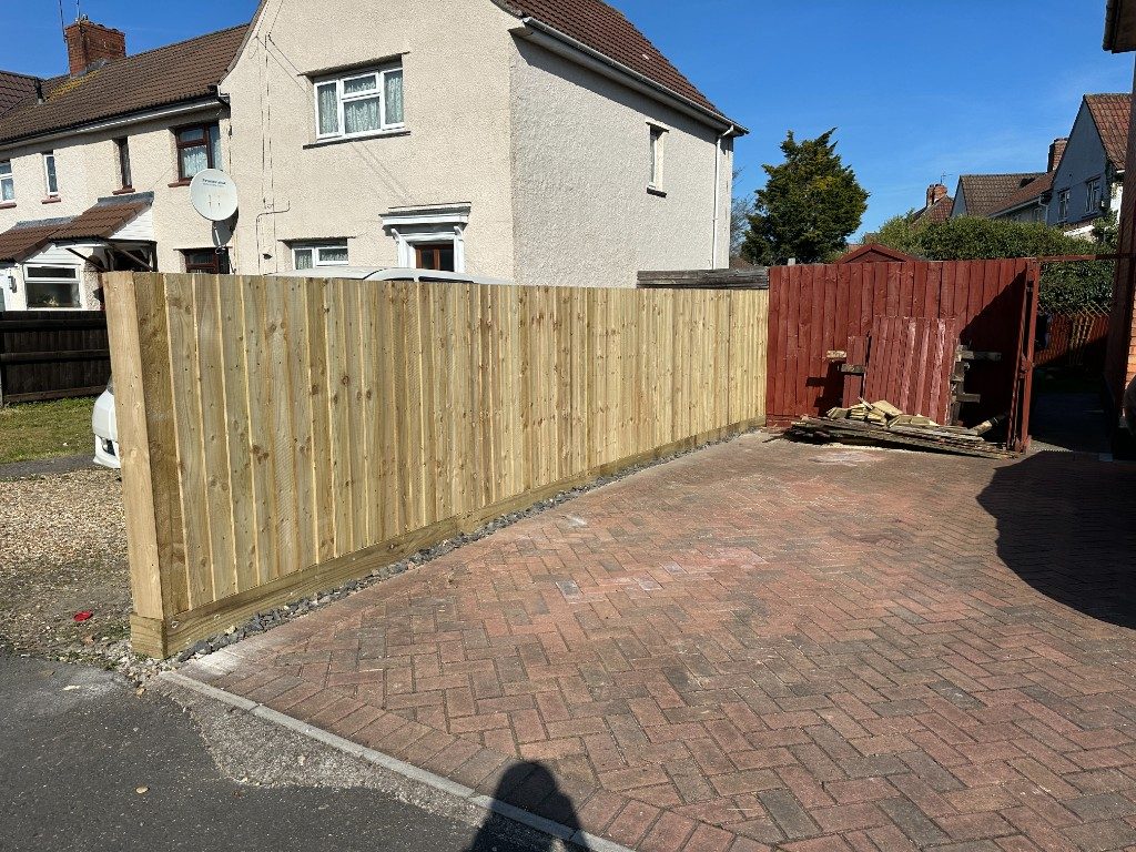 New timber featheredge fencing along a block-paved driveway frontage