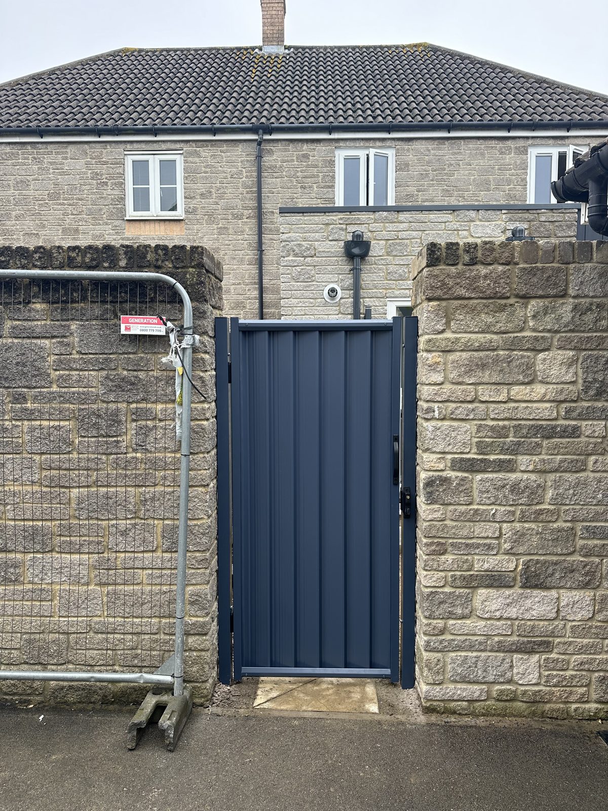 After: a made-to-measure anthracite metal side gate fitted neatly between the stone pillars