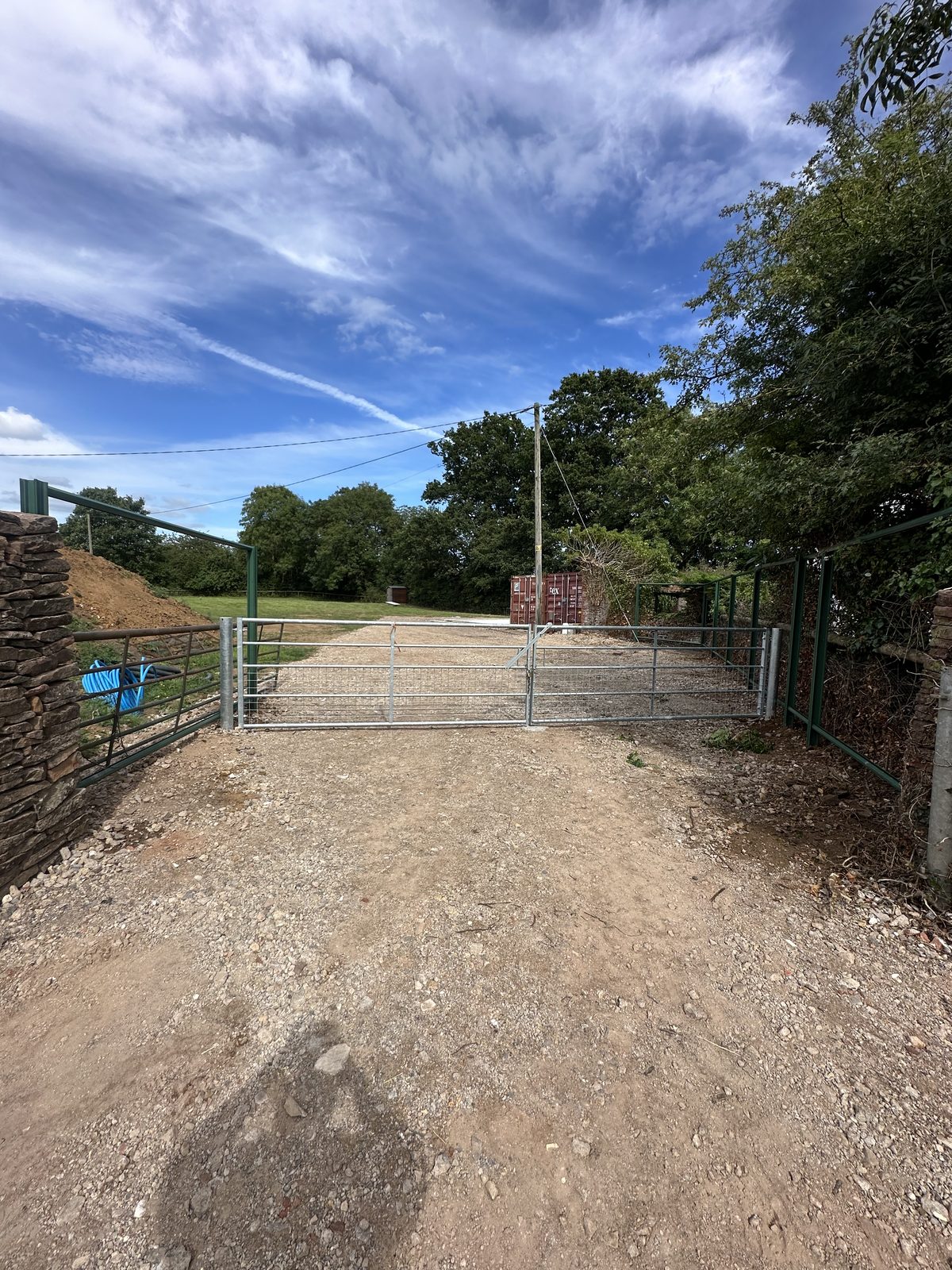 Before: an open rural gateway with a tired boundary