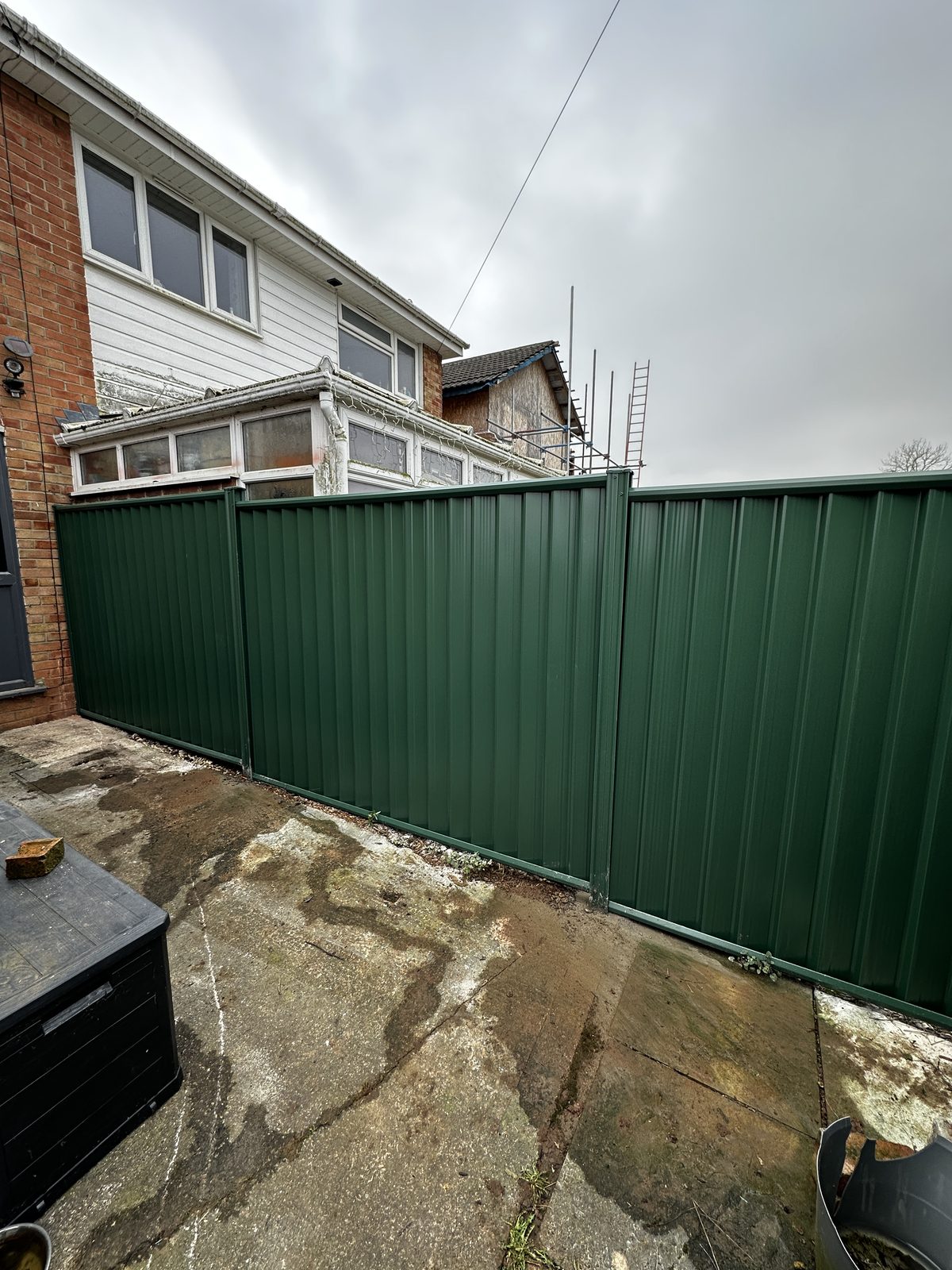 After: new green metal fencing manufactured from Colorbond steel in its place