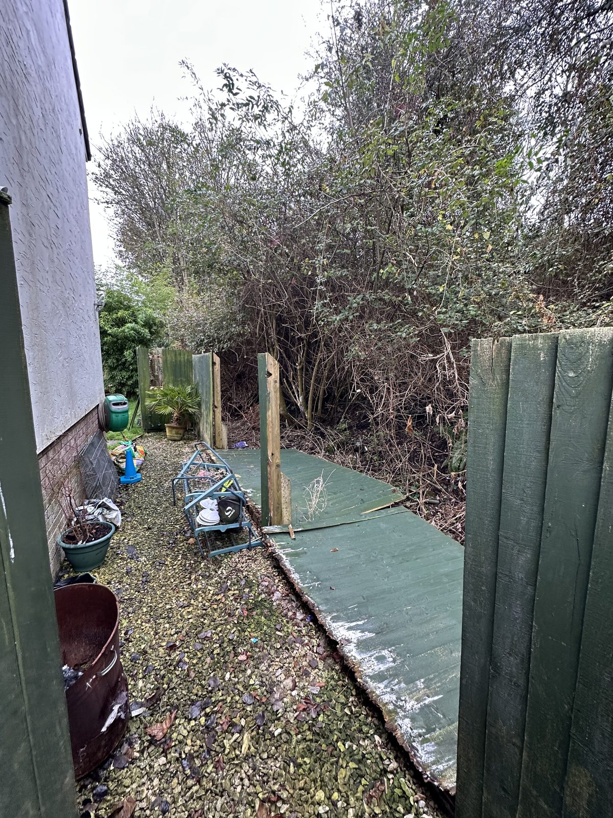 Before: a narrow side passage with an old fence