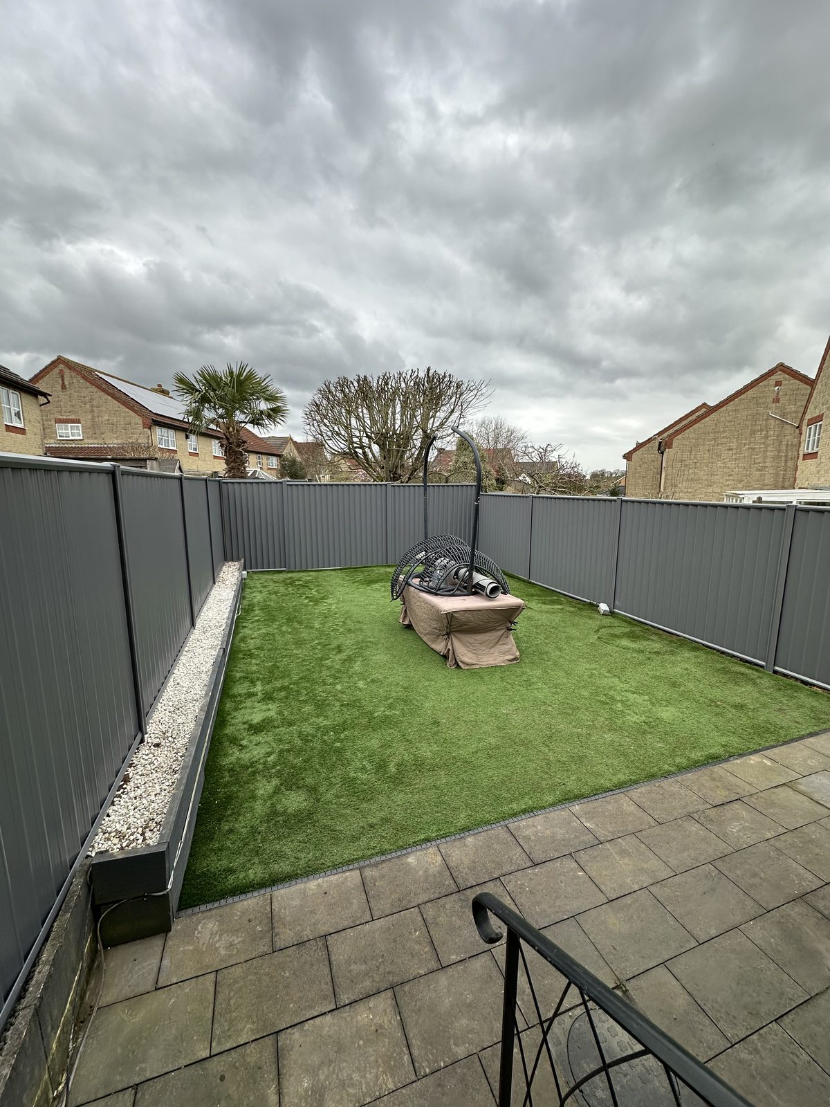 After: grey metal fencing with a slatted privacy top, manufactured from Colorbond steel
