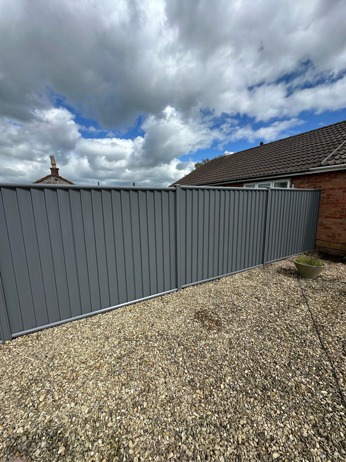 After: clean grey metal fencing manufactured from Colorbond steel