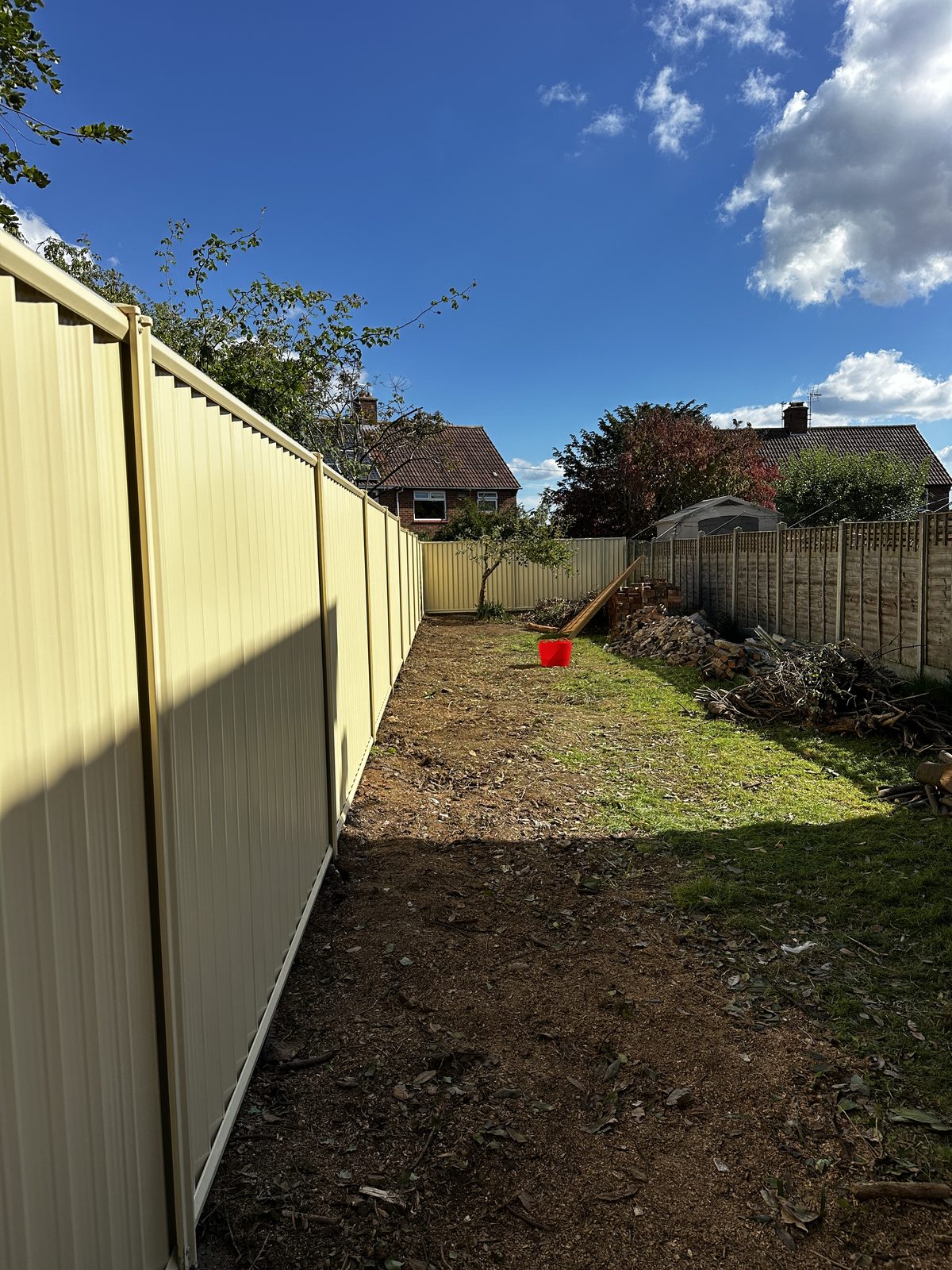 A long perspective run of cream metal fencing