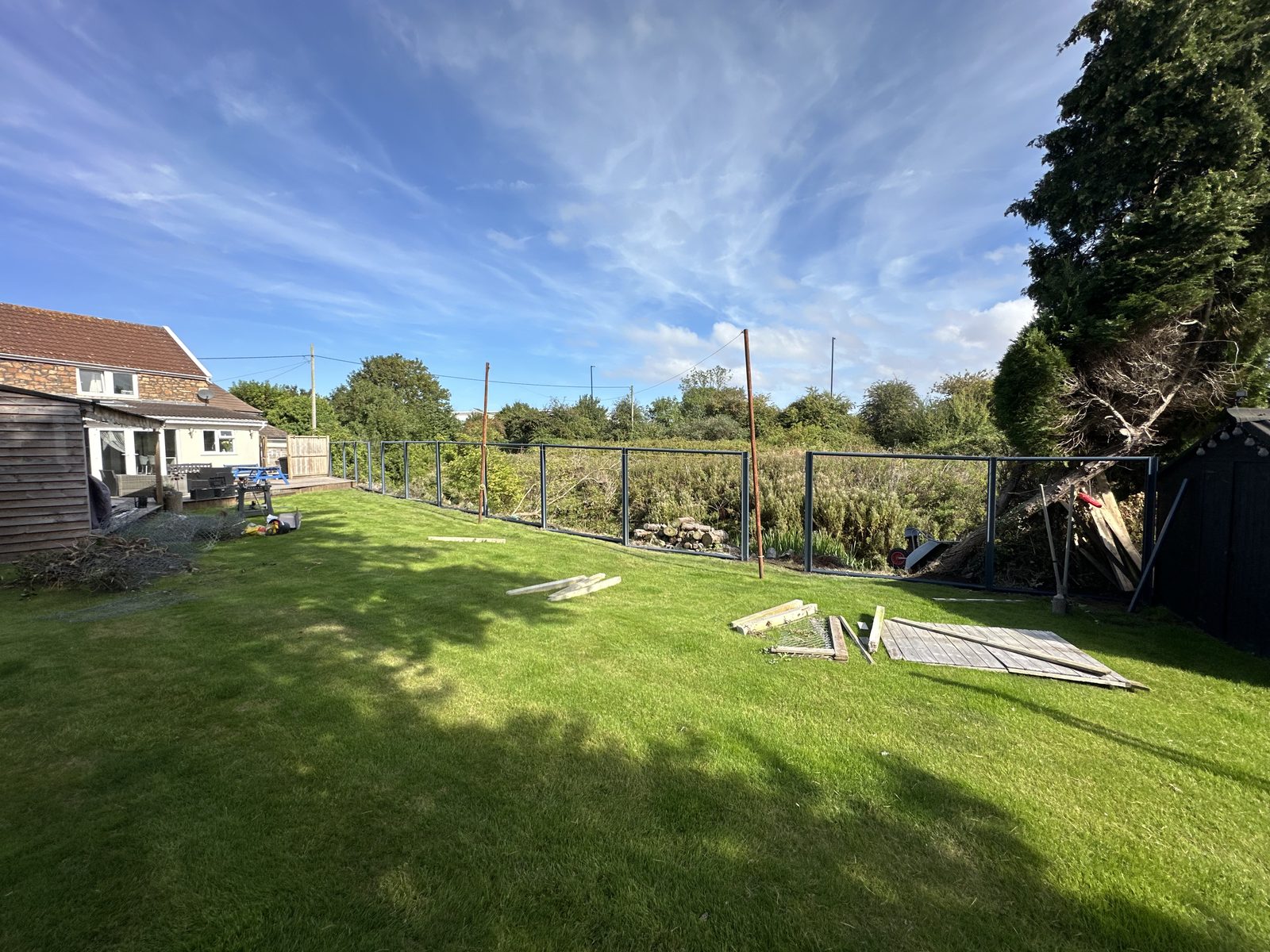 Before: an open boundary along a long rear garden