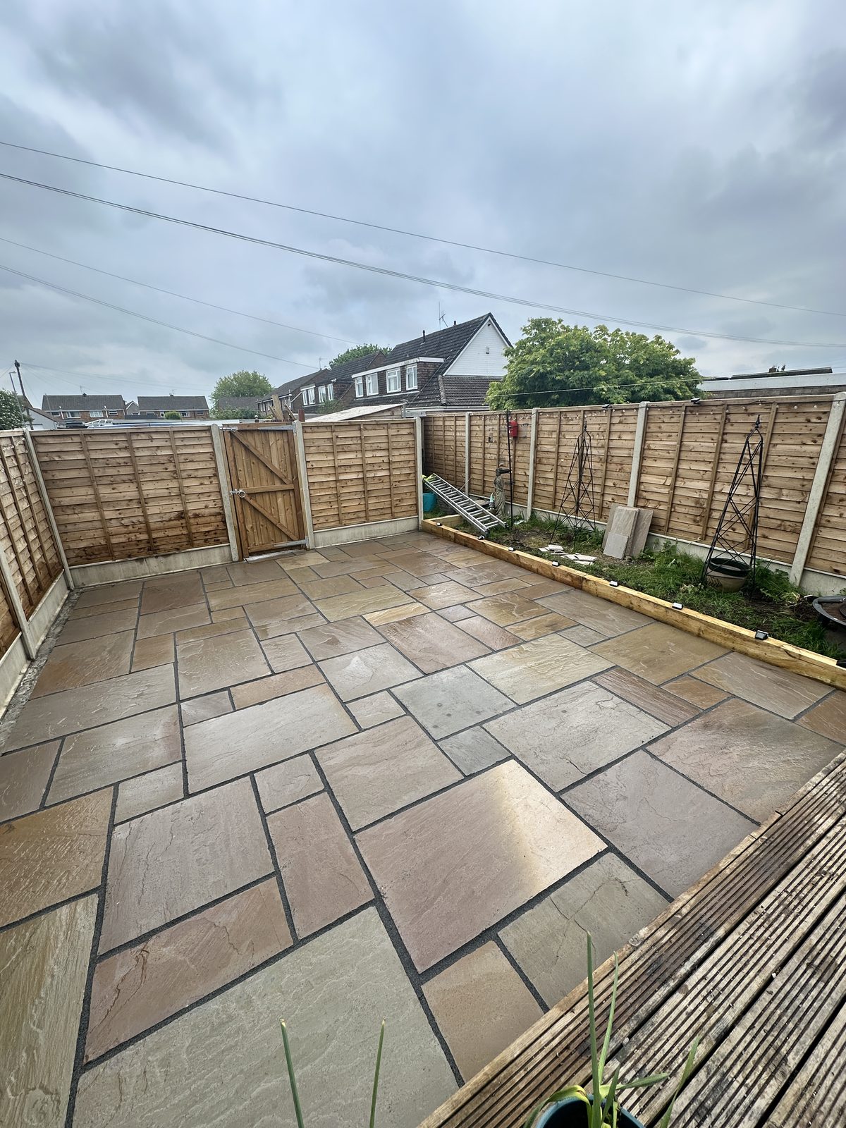 After: a smart new Indian sandstone patio with clean edges and neat pointing