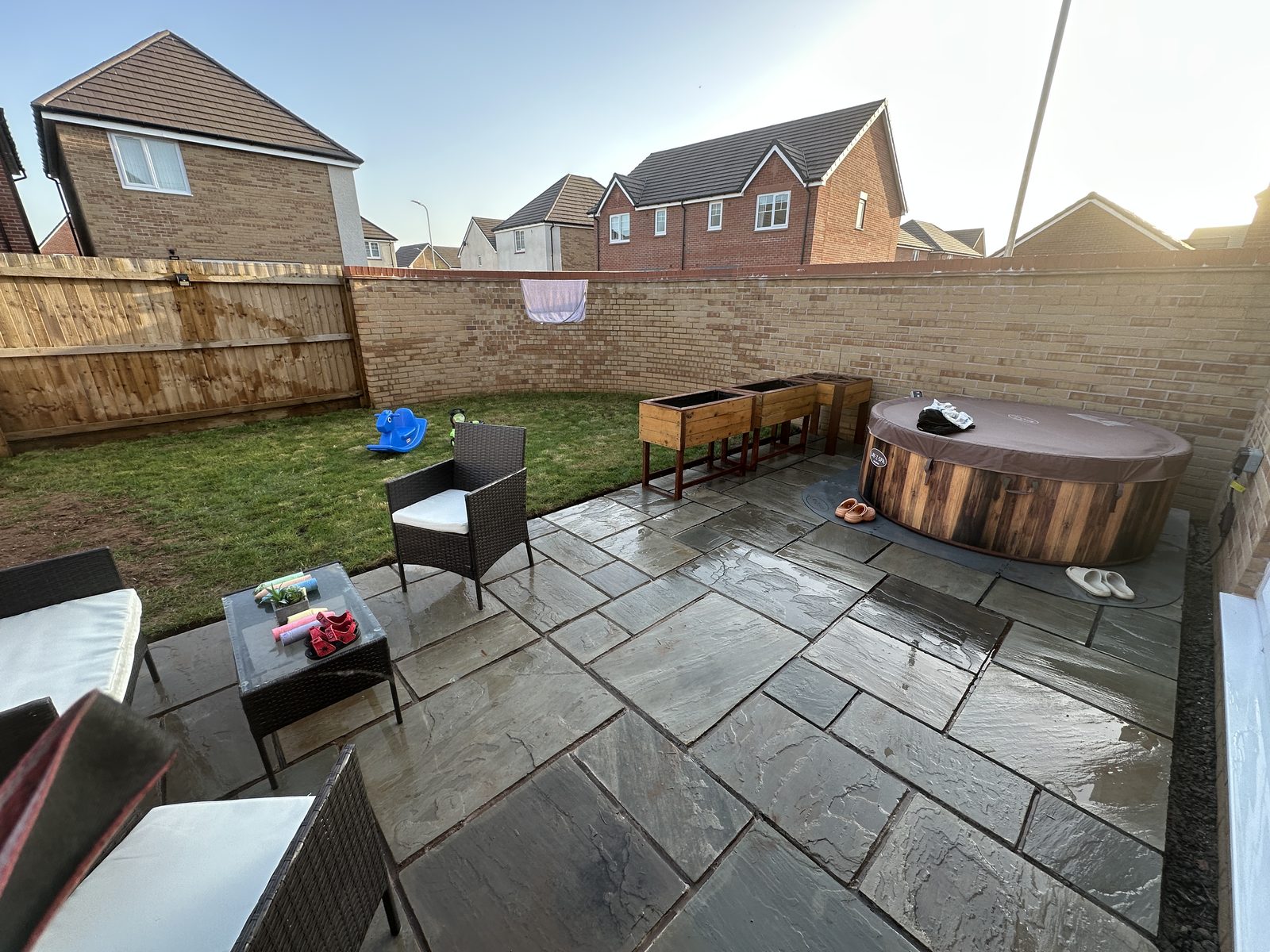 Finished Indian sandstone patio with garden furniture