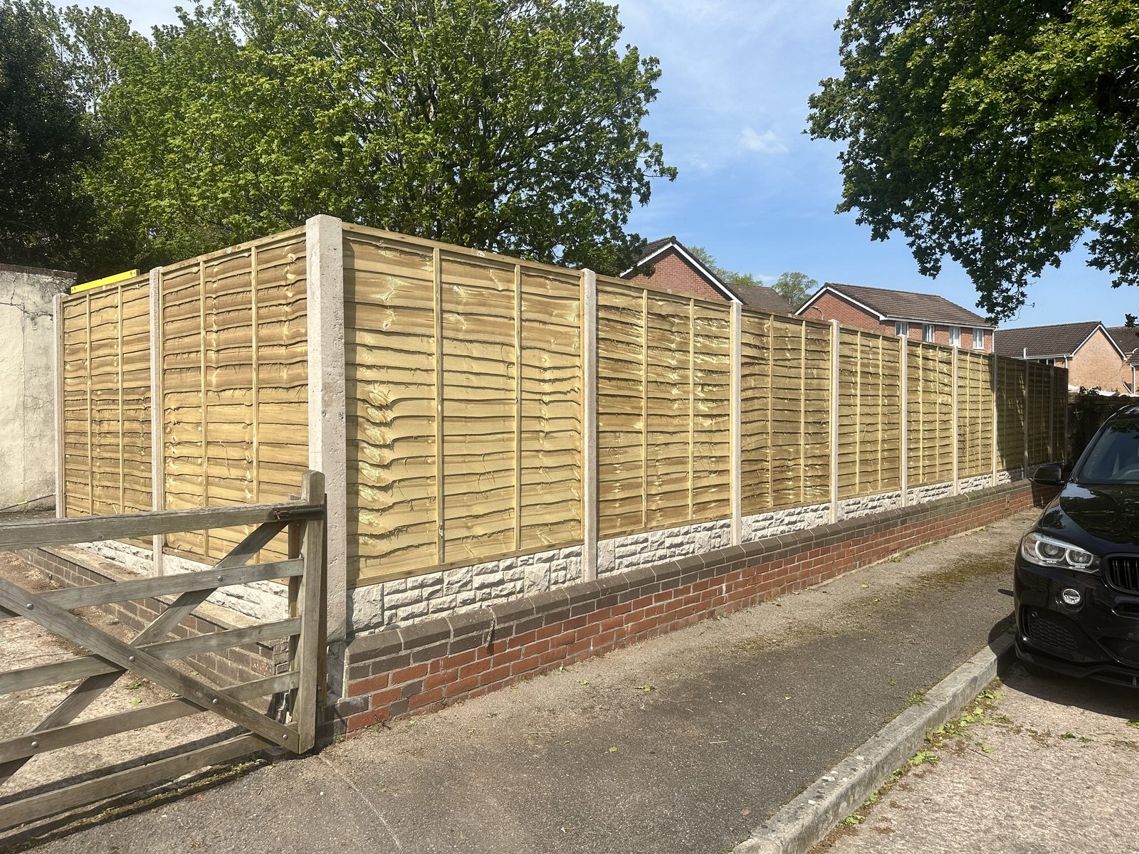After: new timber lap fencing on the existing brick wall