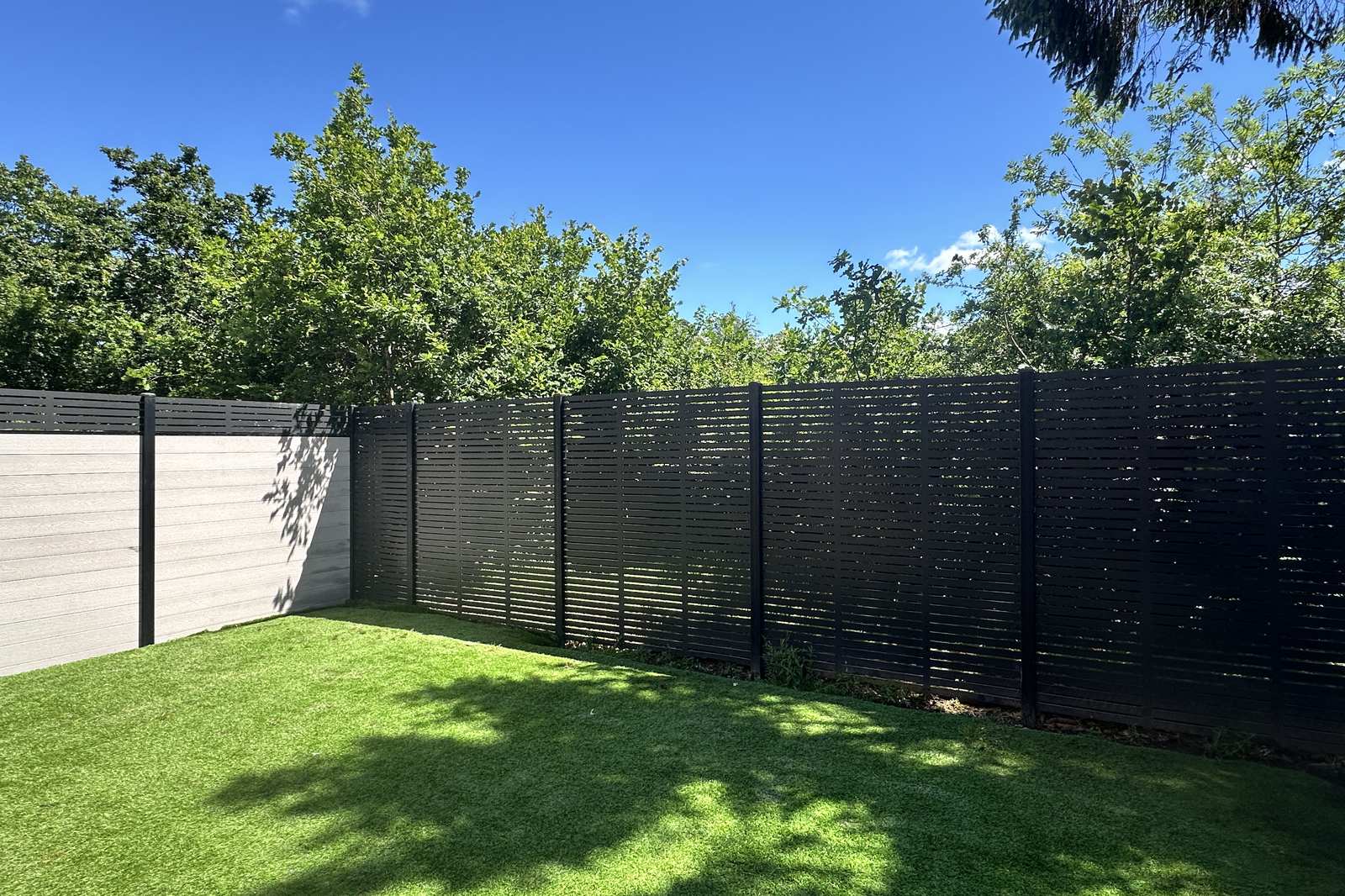 Charles & Ivy composite fencing with slatted fencing designed to maintain light and retain the view of the lake.