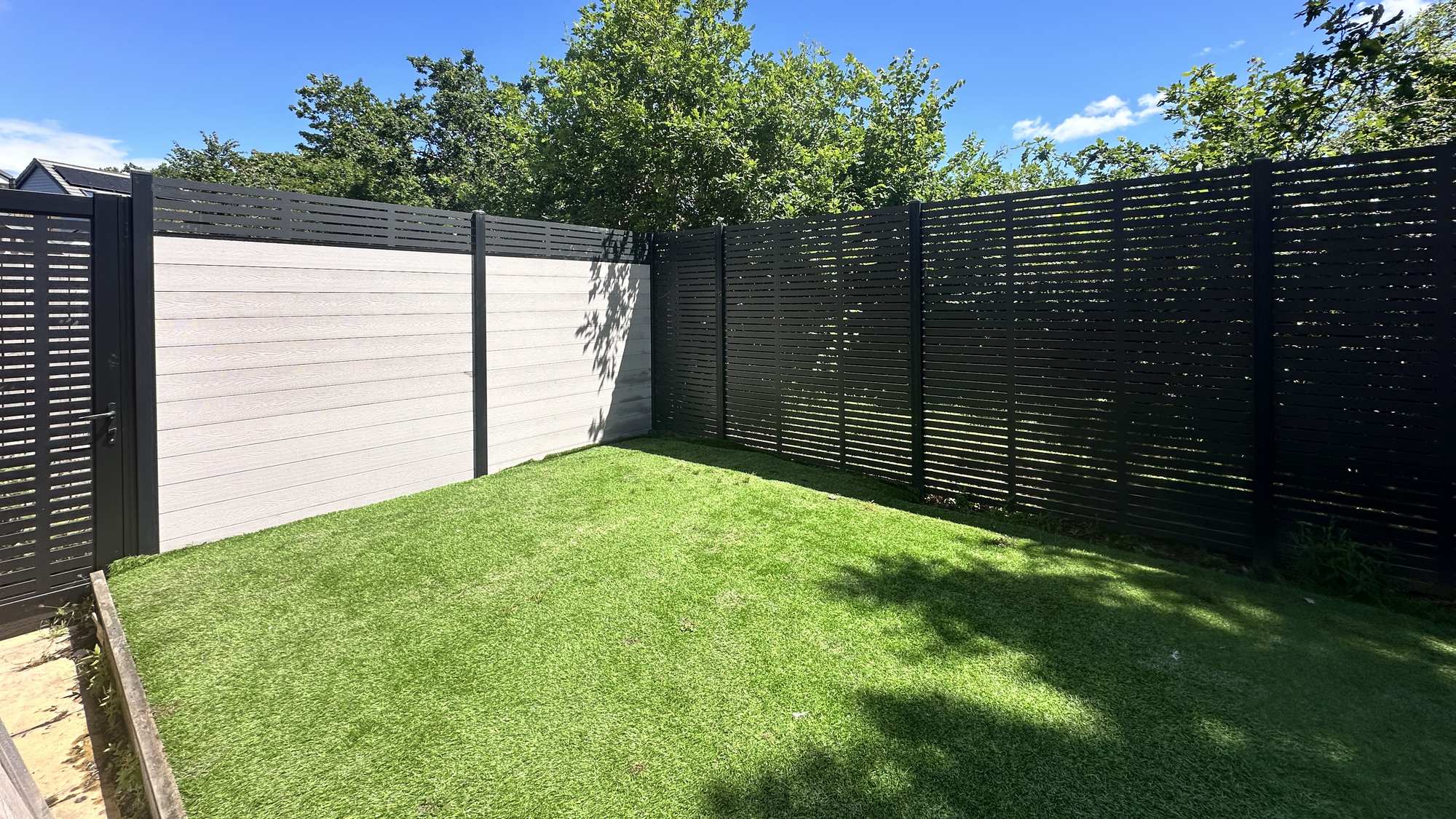 Charles & Ivy composite fencing with slatted fencing designed to maintain light and retain the view.
