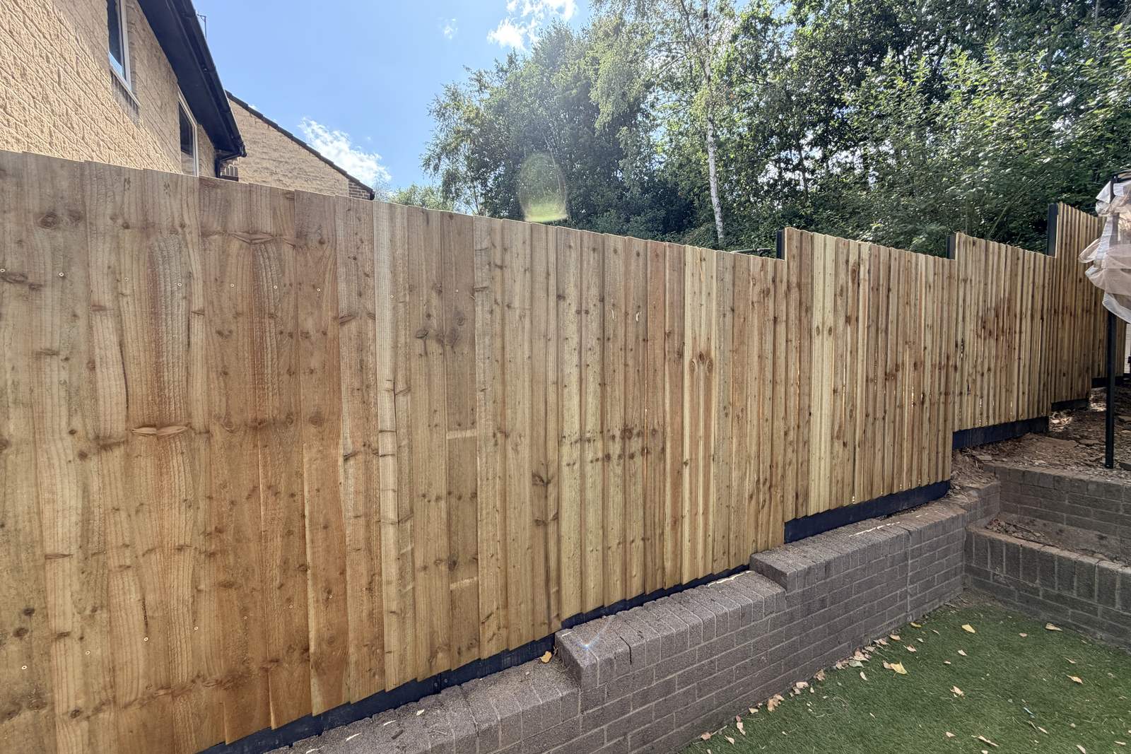 Steel posts and gravel board carrying closeboard timber panels.