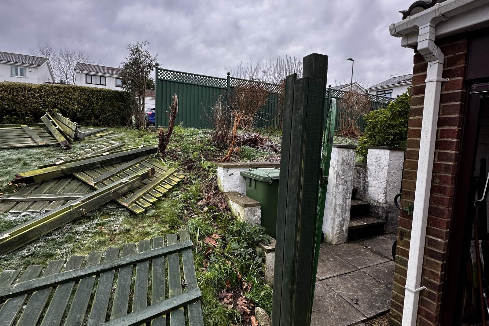 A failed timber boundary fence before replacement.