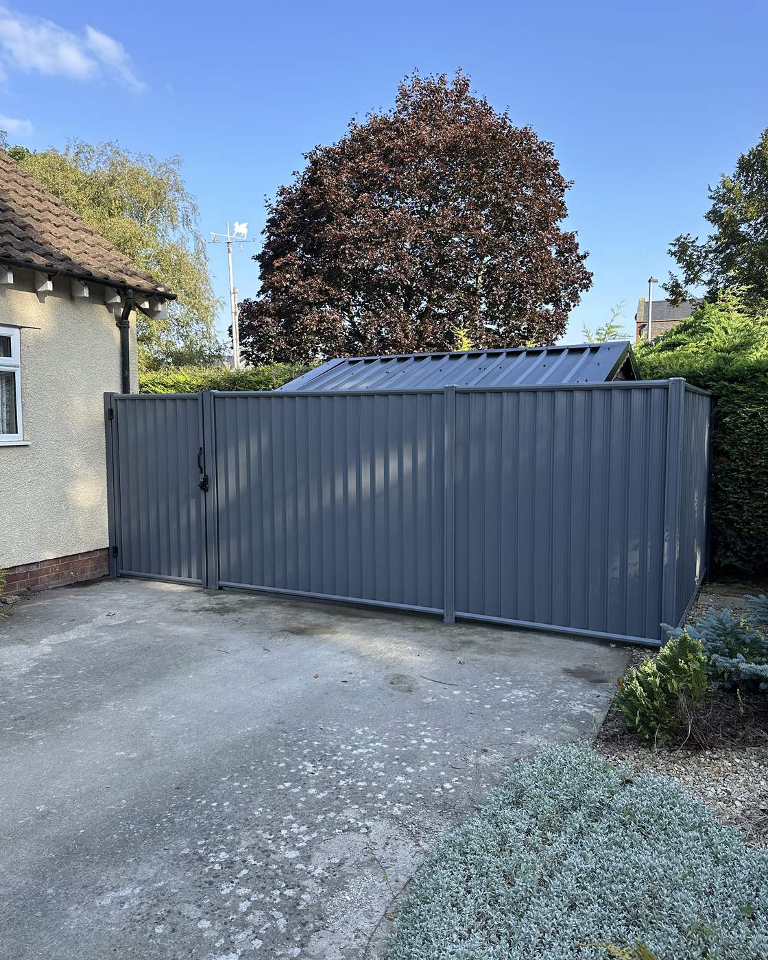 Grey metal double gate and matching side enclosure.