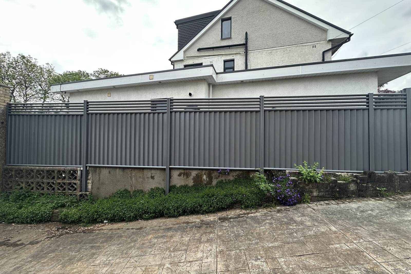 Grey metal fencing to a front boundary.