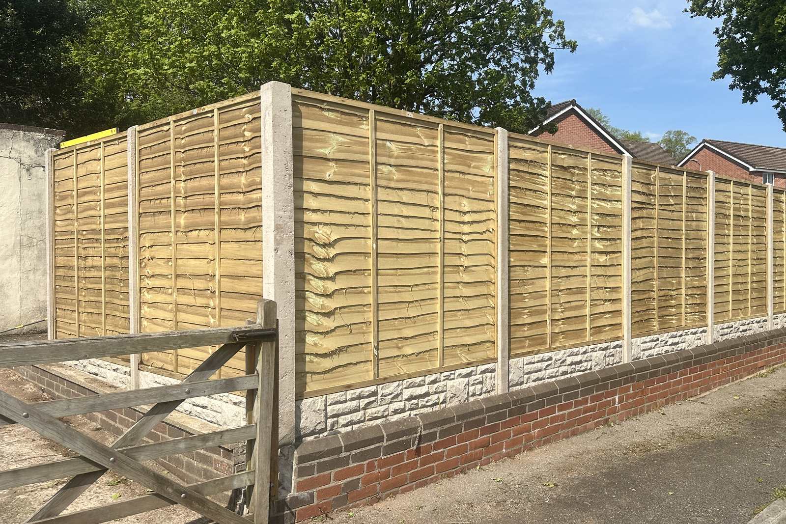 Timber fencing on concrete posts along the cleared boundary.