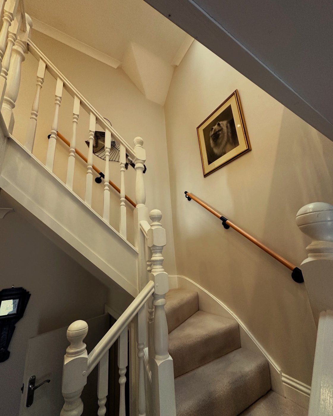 Timber handrails fitted to both sides of an internal staircase.