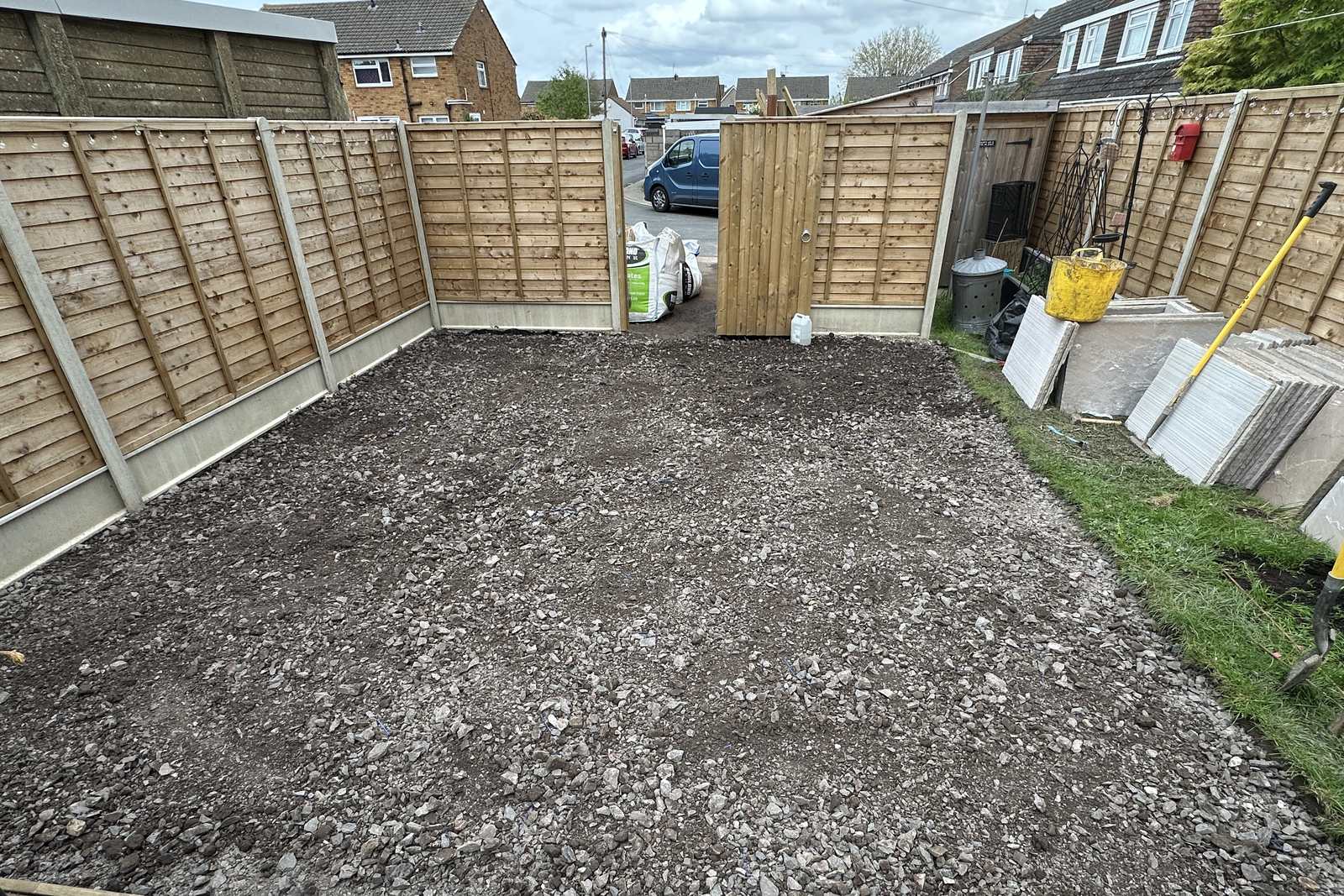 Excavated patio area with a compacted sub-base laid, ready for paving.