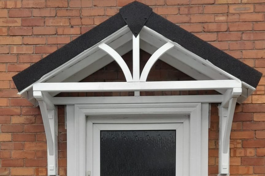 Bespoke timber entrance canopy above a front door.